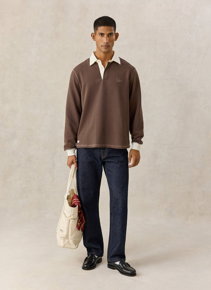 Percival brown rugby polo with dark jeans and tote bag