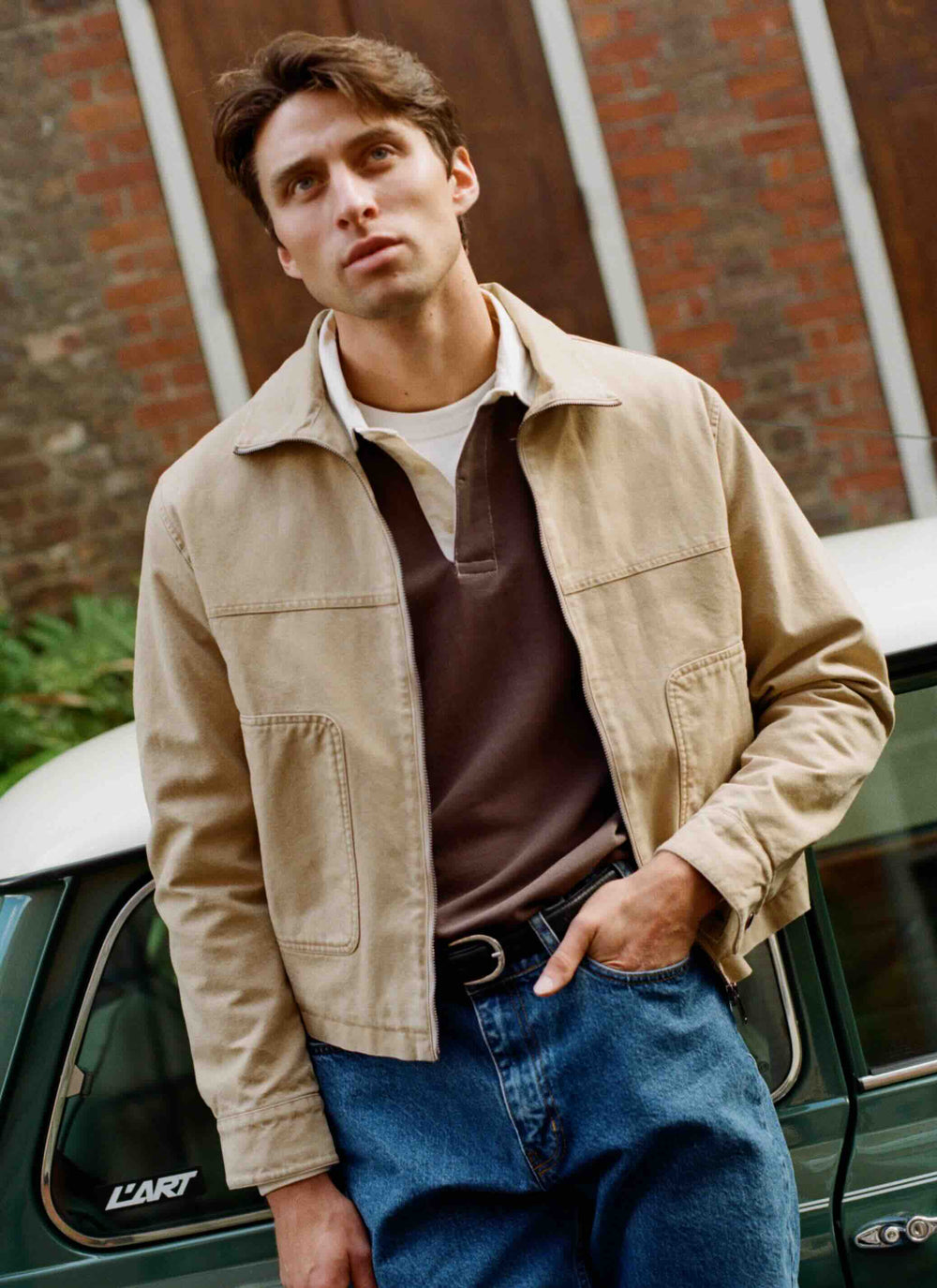 Percival brown Editor rugby polo layered under a beige jacket